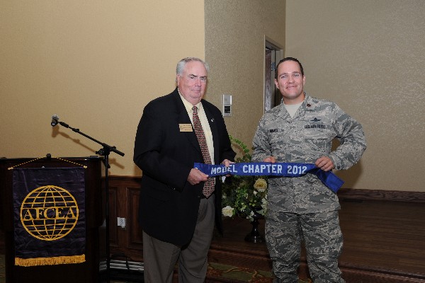 Tom Gwaltney (l), regional vice president, presents Maj. Jeffrey J. Gomes, USAF, chapter president, with the Model Chapter of the Year Award for 2012 at the July luncheon.